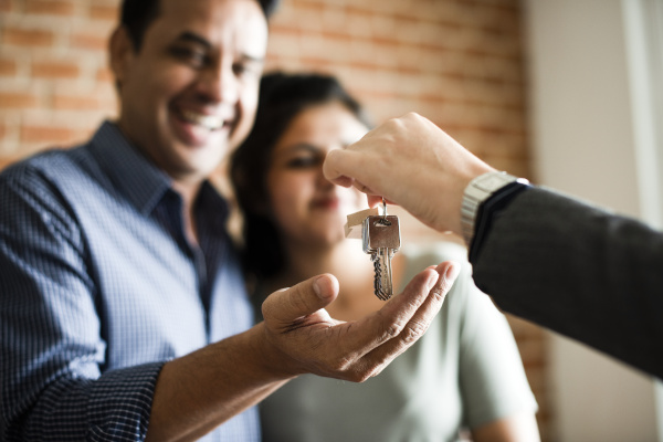 person handing over keys