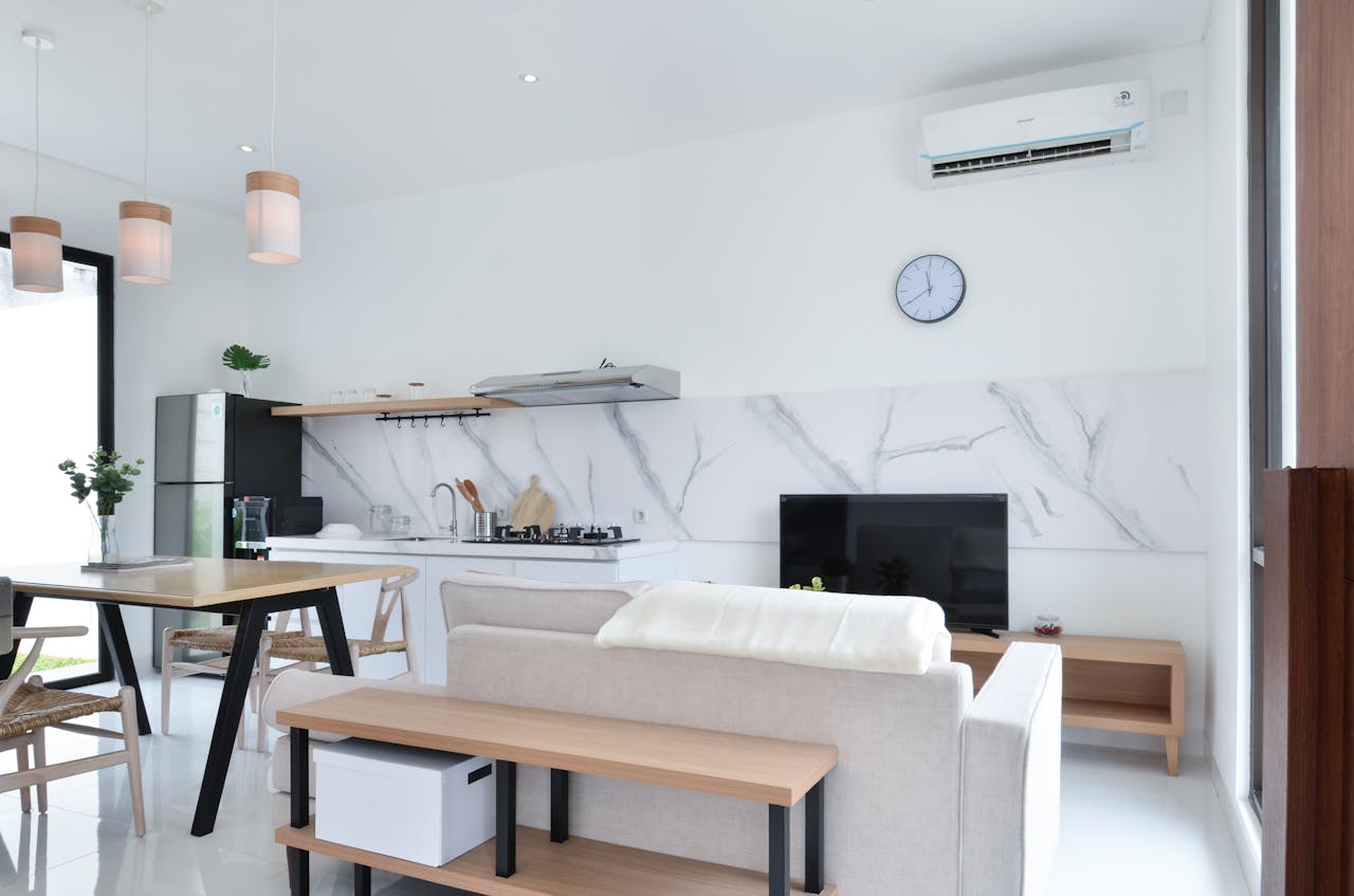 Livingroom kitchen combo. Air conditioner unit on wall.