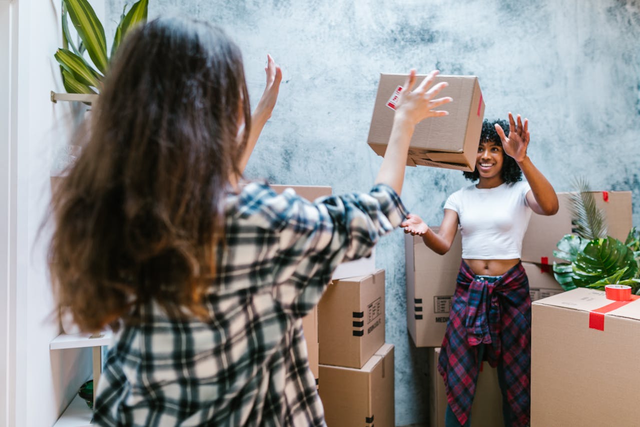 2 students with moving boxes