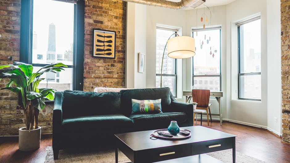 Livingroom with a green sofa. Image by Pexels