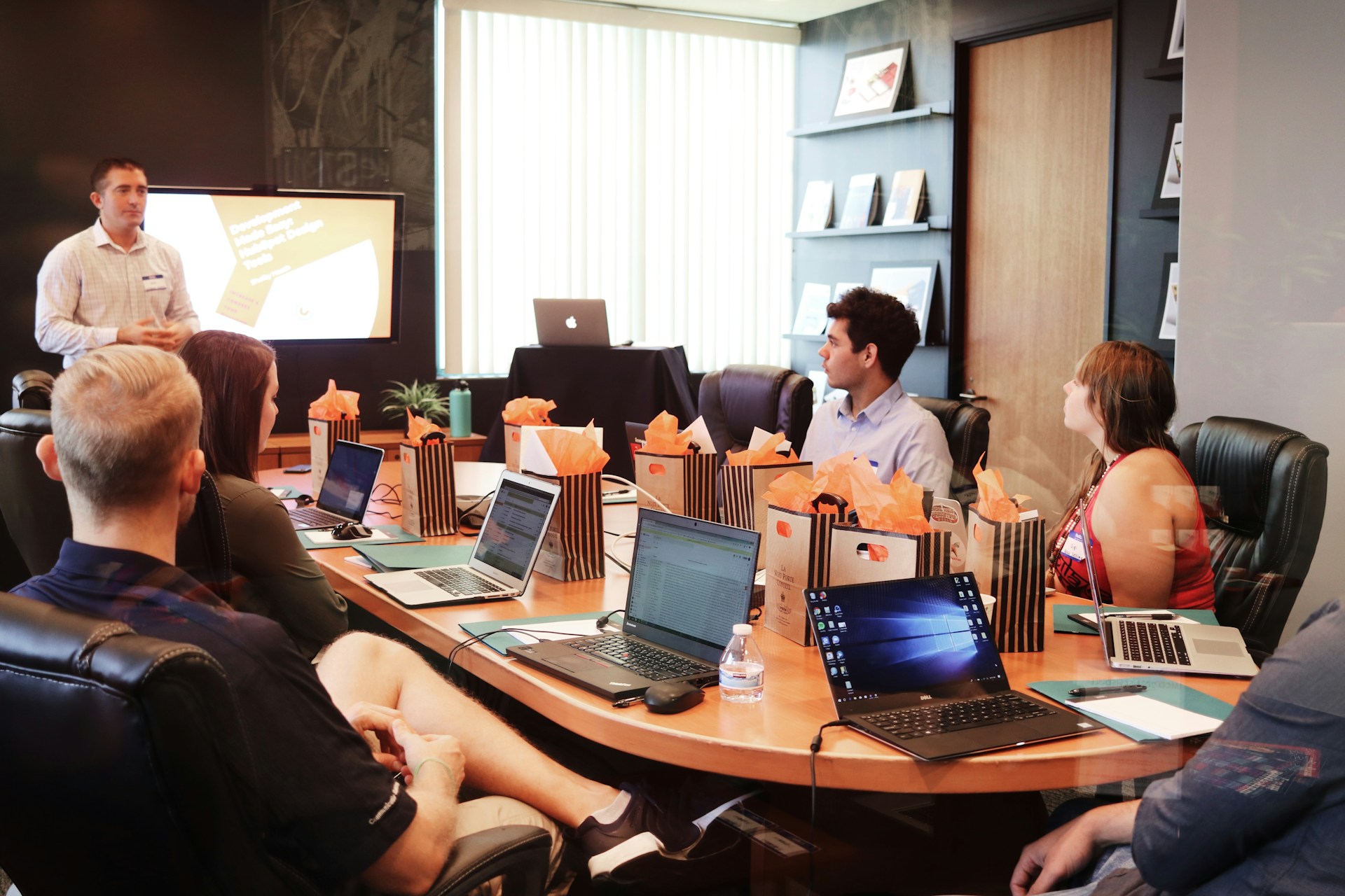 Executives in a meeting discussing what does a request for proposal do. Imagbe by Unsplash