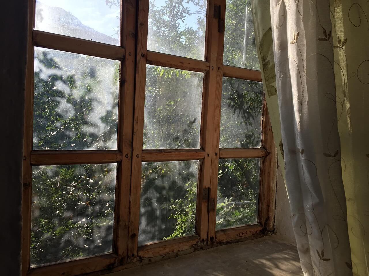 Sun shining through old wood windows. Image by Pixabay