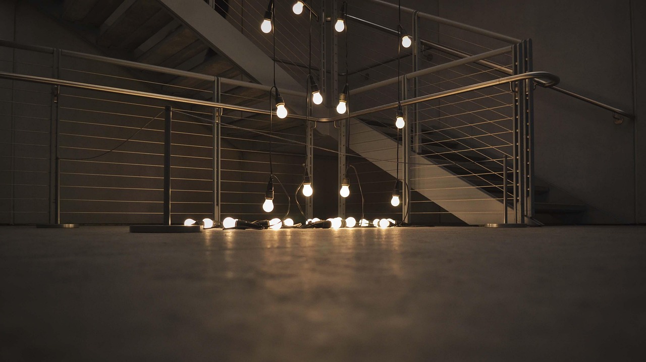 Illuminated lightbulbs hanging in a row showing different bulb types for home lighting. Image by Pixabay