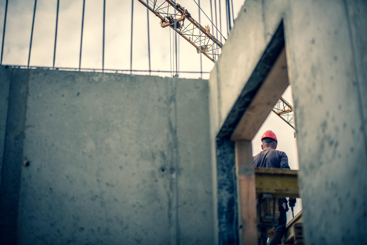 Construction worker in red hard hat. Image by Pixabay