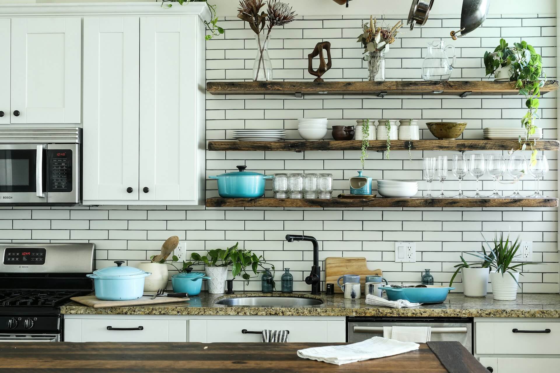 Bright modern compact urban kitchen with open shelving and clean layout. Image via Unsplash