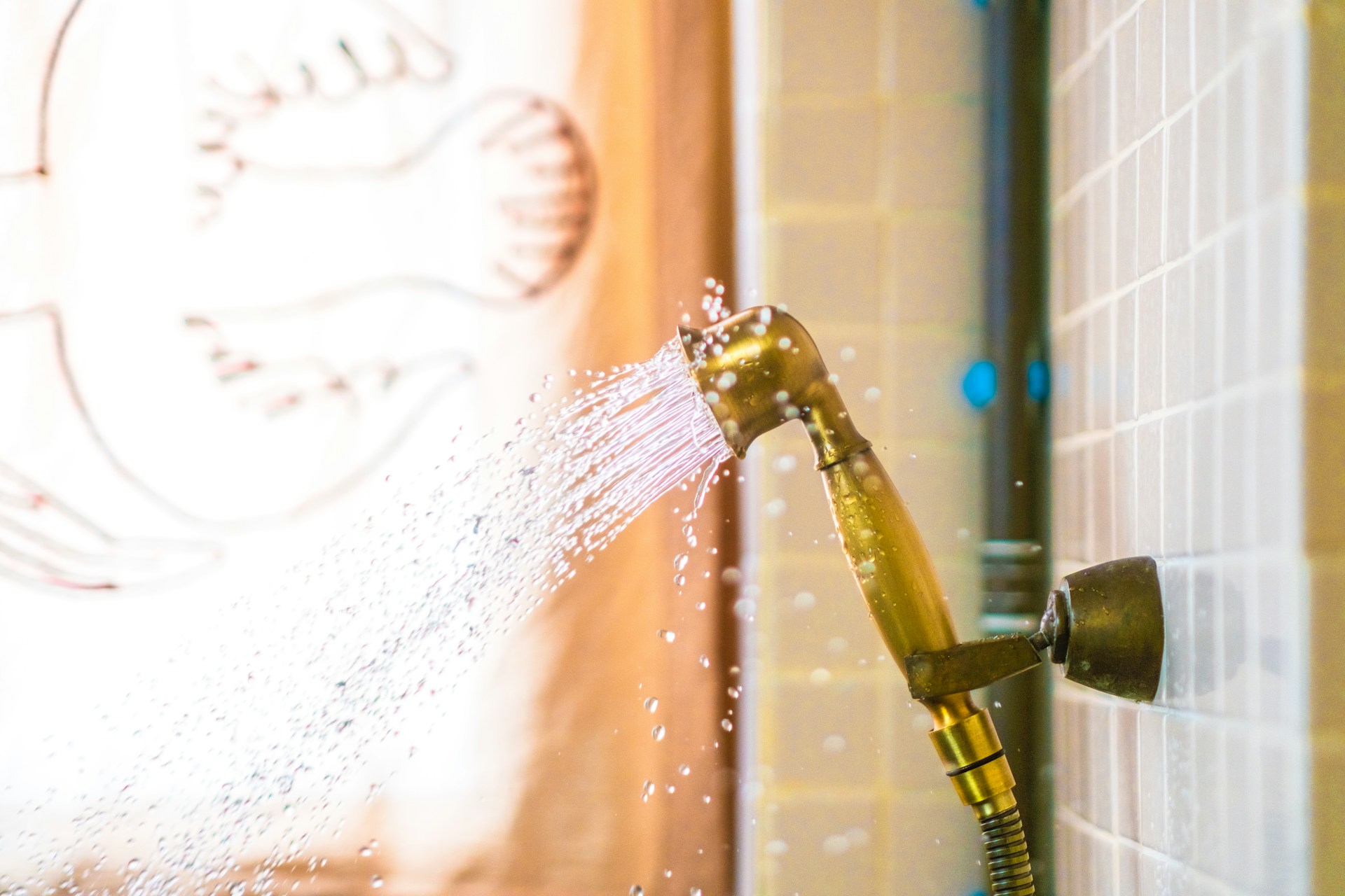 golden shower head spraying water