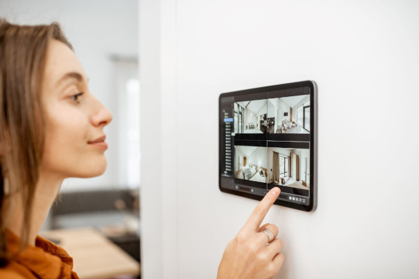 Person checking a device on the wall