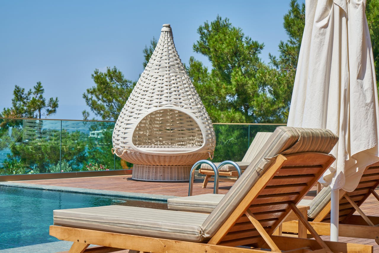 Li9unge chairs next to a pool.