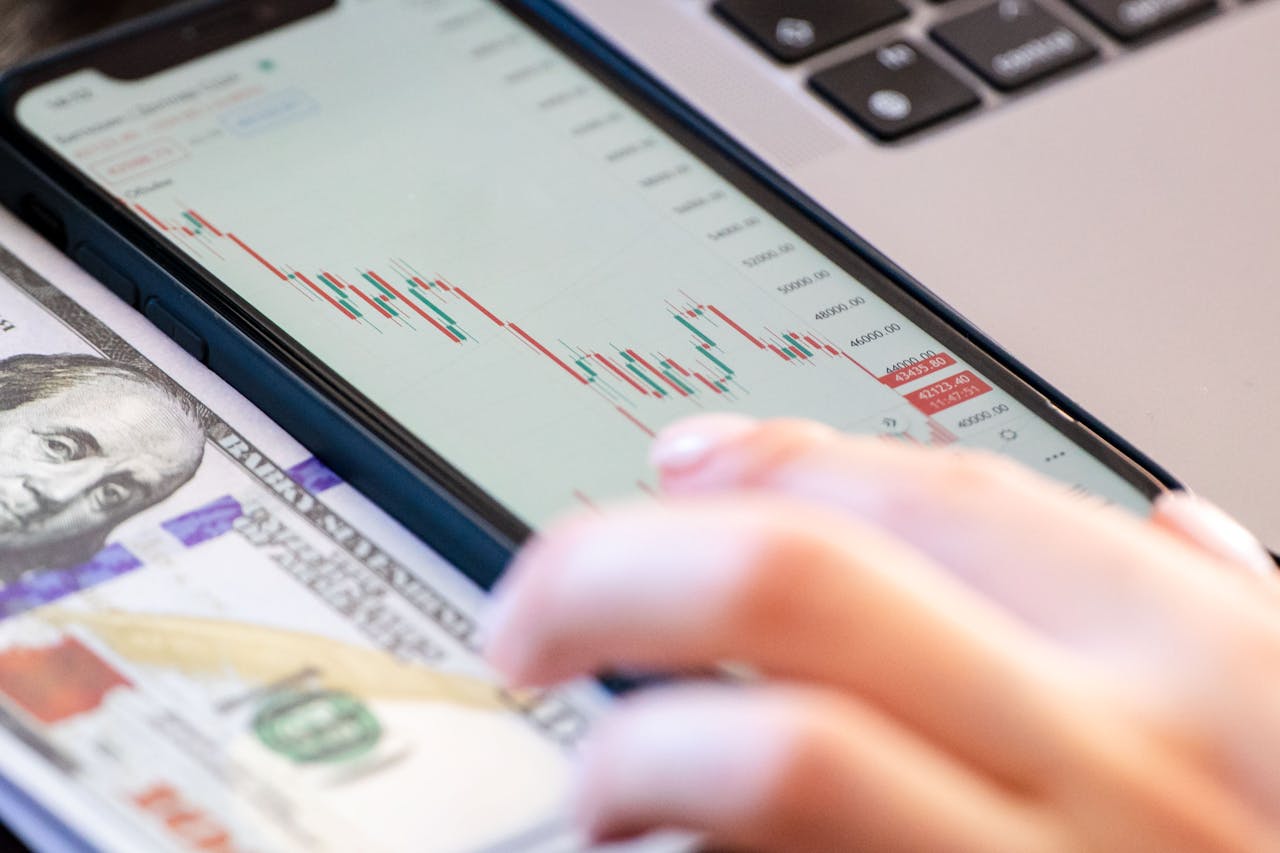 Person using a smartphone for business. Money. Image by Pexels