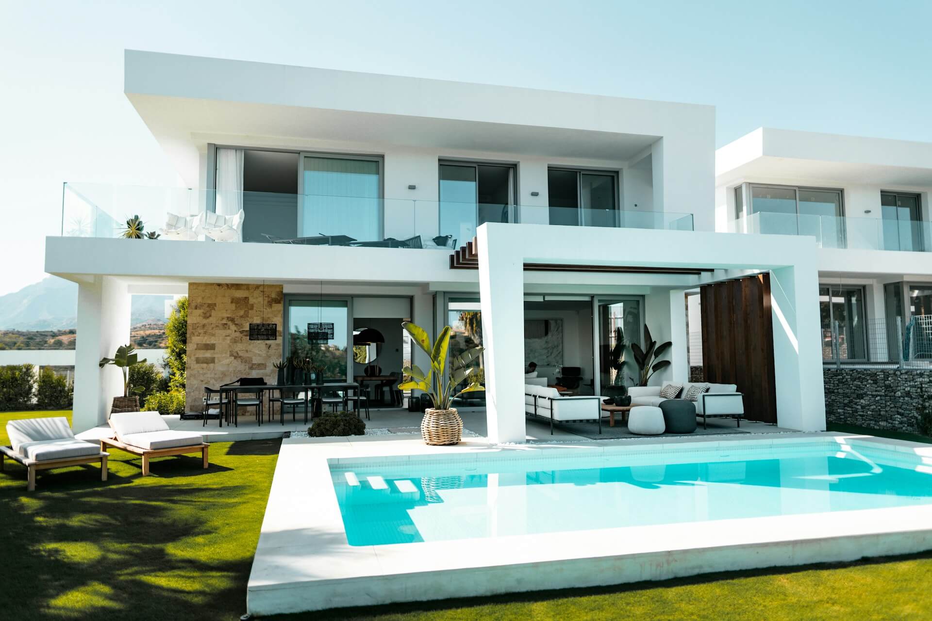Large white concrete house with a pool