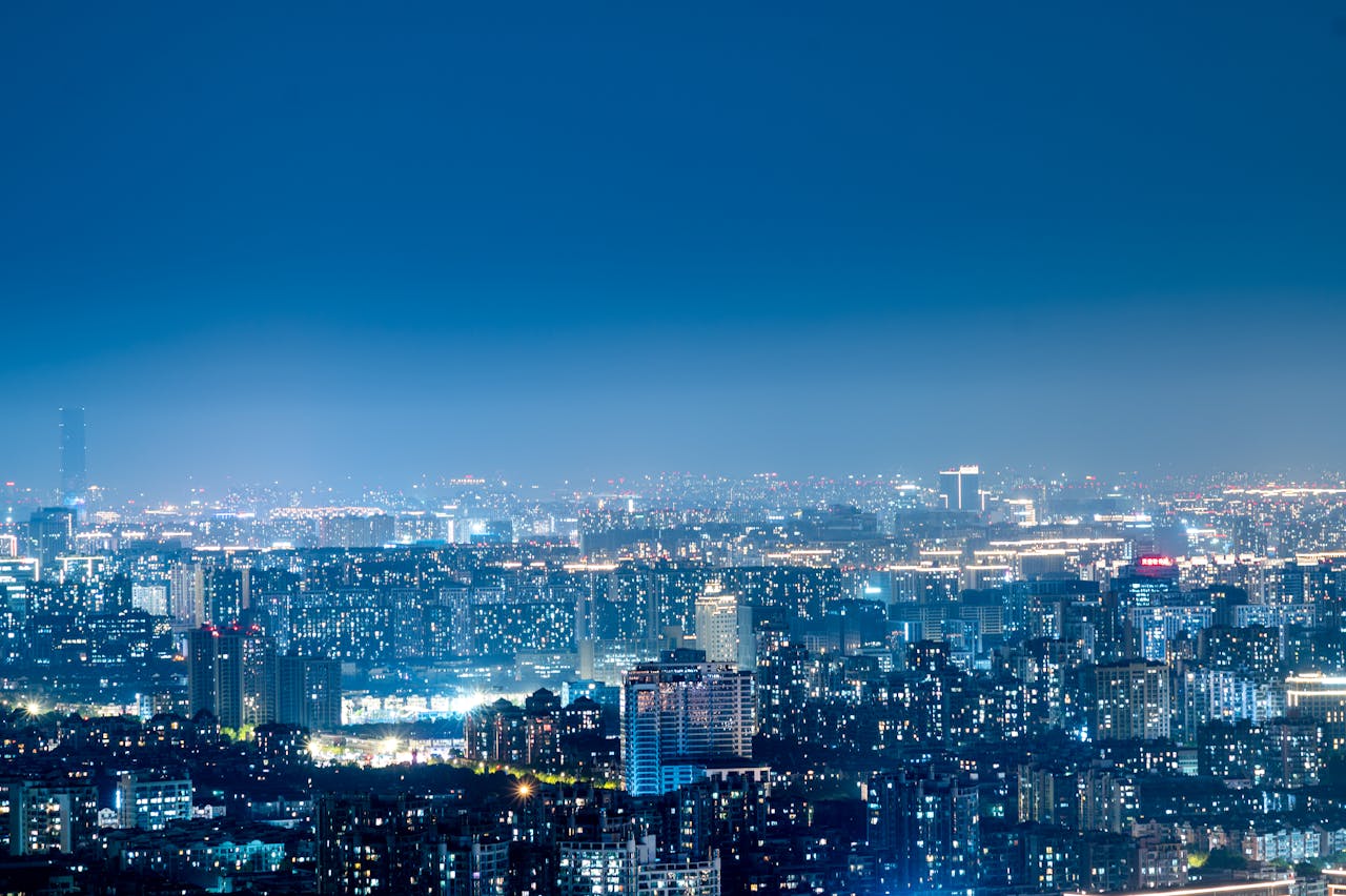 Vibrant night skyline of modern cityscape. Image by Pexels
