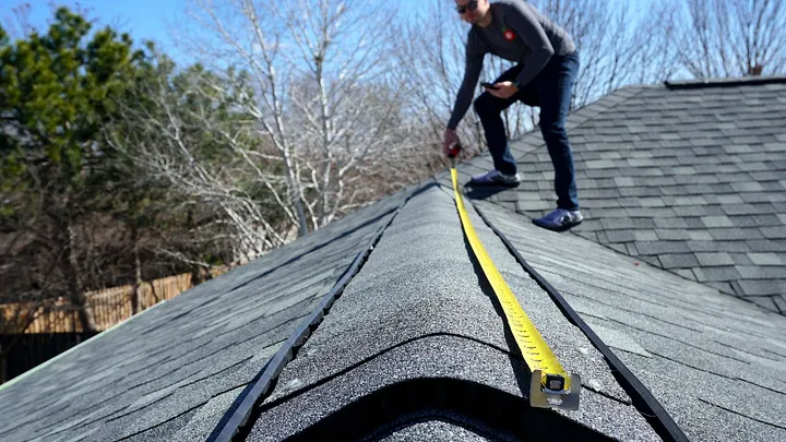 Roofer measuring
