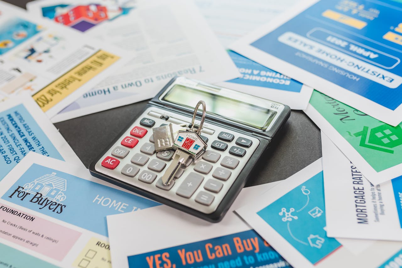Calculator on top of paperwork. Image by Pexels