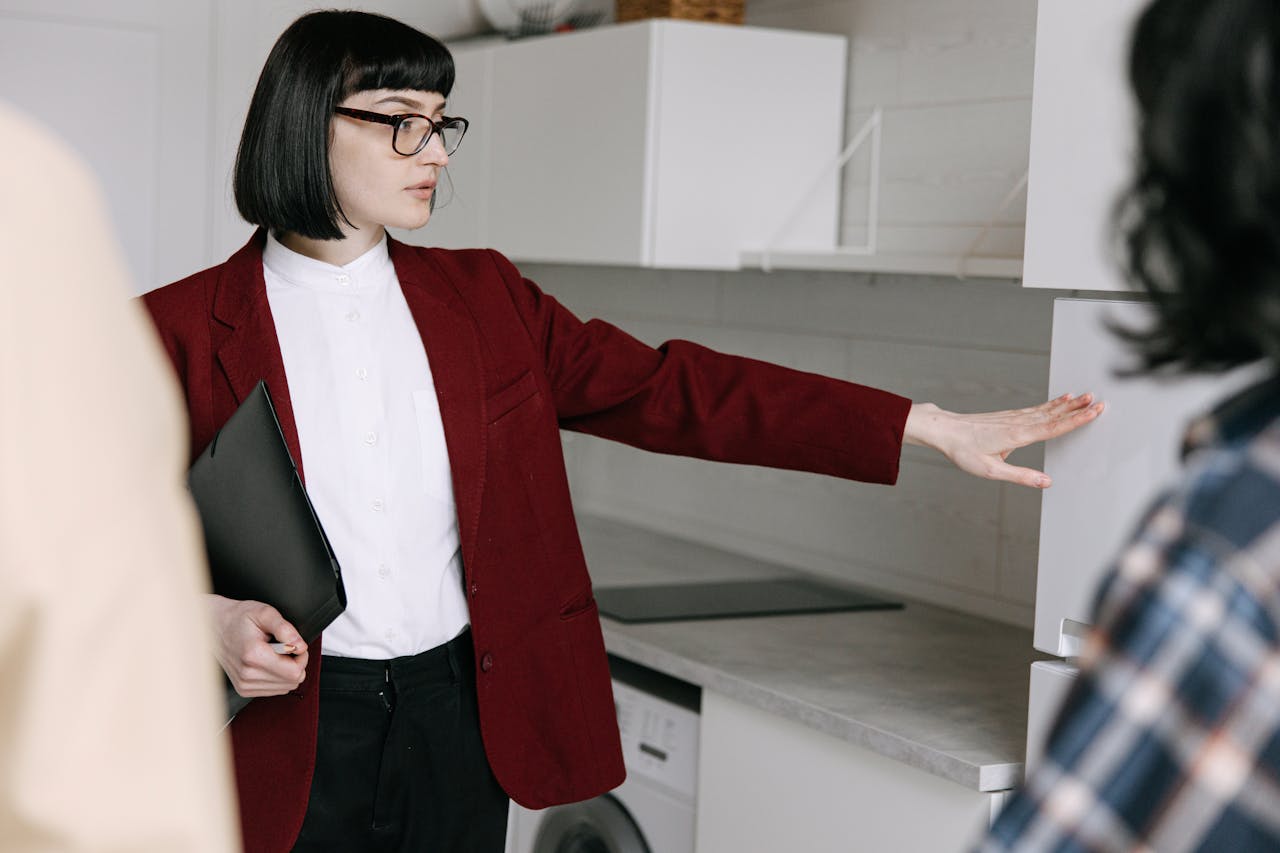 A person showing a new kitchen. Iamge by Pexels