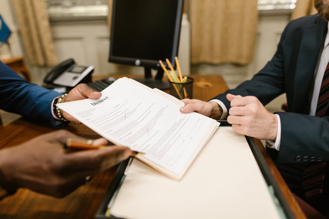 Person holding divorece papers. Image by Pexles